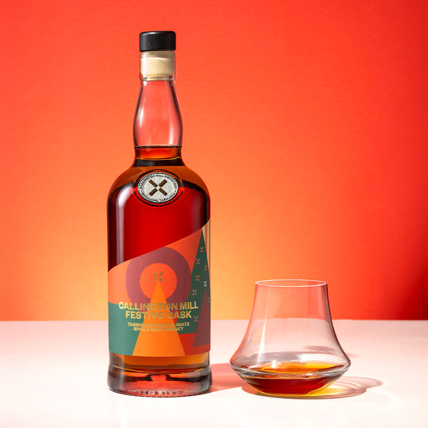 Callington Mill Festive Cask Tasmanian single malt whisky bottle with a glass, a Christmas whisky gift